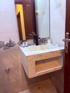 a bathroom with a sink and a mirror at أوريانا Oriana in Jeddah