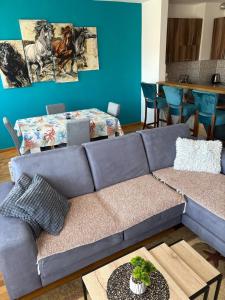 a blue living room with a couch and a table at Sophia in Vranje