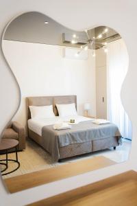 a white bedroom with a bed and a chair at Hotel Ricardo Residence in Ulcinj +143 photos