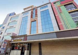 a building with a sign on the front of it at Hotel Swarna Mayuri in Guntūr