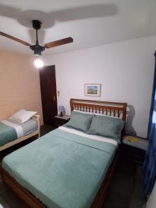 a bedroom with two beds and a ceiling fan at Hostel Iguabella - RJ in Iguaba Grande +118 photos