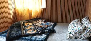 a bedroom with two beds with pillows and a window at Wang Homestay in Sukhia Pokhari +49 photos