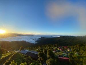 a view from the top of a mountain with the sun setting at Wang Homestay in Sukhia Pokhari