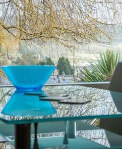 a blue bowl sitting on top of a glass table at Bagshaw Lodge in Bakewell