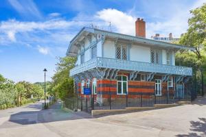 an old house with a fence in front of it at The Spa Chalet Scarborough Hot tub, pool, gym, beach location in Scarborough