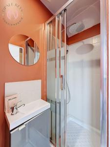 a bathroom with a sink and a shower at Le Studio Bleu - Dernier etage & Confort in Coudekerque-Branche