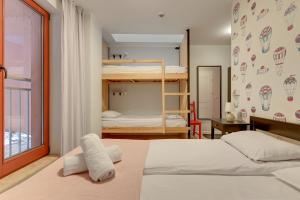 a bedroom with two bunk beds and a window at WaterLane Island Hostel&Apartments in Gdańsk