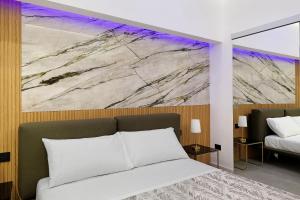 a bedroom with a bed and a painting on the wall at La Rocca D’Amuri in Partinico