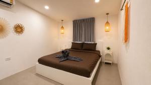 a small bedroom with a bed in a room at Sawan villa in Hinkong +8 photos