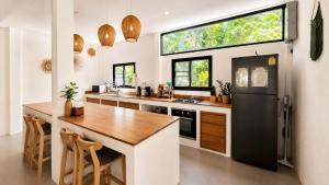 a kitchen with a counter and a large window at Sawan villa in Hinkong