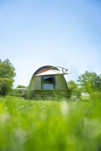a round building in a field of grass at Lodge des Bois Jacuzzi in Target