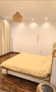 a bedroom with a bed in a room at Azure liwa in An Nashshāsh