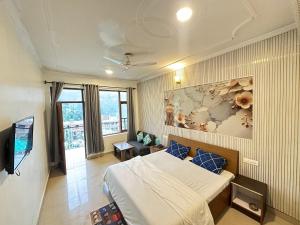 a bedroom with a bed and a painting on the wall at Backpacker Inn Mcleod in Dharmsāla
