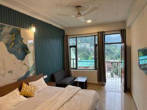 a bedroom with a bed and a chair and a window at Backpacker Inn Mcleod in Dharmsāla