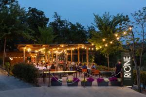 a restaurant with people sitting at tables at night at hu Firenze Certosa Camping in Town in Impruneta +98 photos