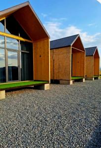 a row of buildings sitting on top of gravel at AnArt resort in Vanadzor