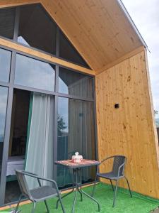 a small wooden house with a table and chairs at AnArt resort in Vanadzor