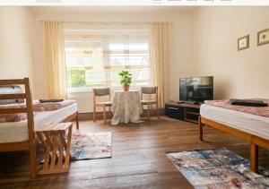 a living room with two beds and a television at Ein Zuhause auf Zeit in Osterburg