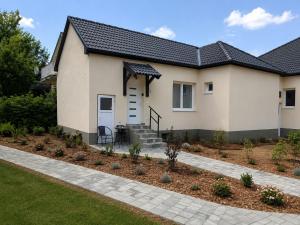 a house with a black roof at Garden Home in Törökbálint