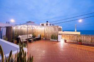 a patio with a couch and a view of the ocean at El Templo Surf House in Punta Hermosa +100 photos