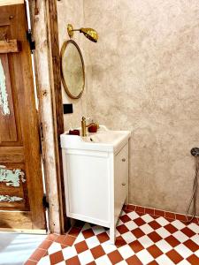 ein Badezimmer mit Waschbecken und Spiegel in der Unterkunft K's Studio in Kuldīga + 29 Fotos