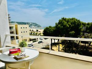 a balcony with a table and a view of a beach at Trill Mirasol E estudio 1a linea mar in L'Estartit