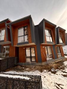 a house under construction in the snow at Fughuro cottage in Bakuriani