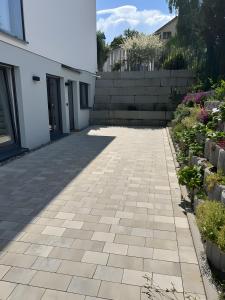 a courtyard of a house with a stone walkway at Moderne Studio Oase in Donaueschingen