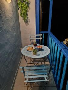a table with a plate of food on a balcony at Blue House in Ucanha
