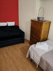 a bedroom with a bed and a dresser at Blue House in Ucanha