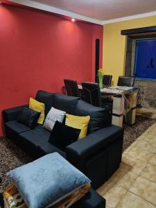 a living room with a couch and a table at Blue House in Ucanha
