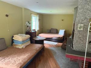 a living room with two beds and a couch at Saules nams in Rucava