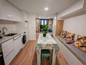 a kitchen with a table with a plant on it at Apartamento com charme no centro histórico - Escura 36 in Viseu +7 photos