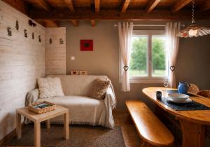 a living room with a couch and a table at Duplex le Grimpeur - Les Apparts du Sancy in Chastreix
