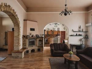 a living room with a couch and a fireplace at Levander Apartmenthouses in Makó