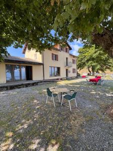 a table and chairs in front of a house at Ritrovo Neggia in Vira