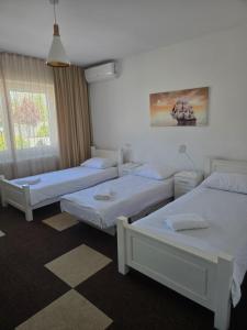 a room with three beds and a window at MB apartmani Sarajevo in Sarajevo +28 photos