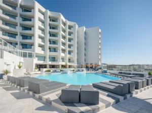 an image of a swimming pool in front of a building at The Salmar - Adults Only in San Miguel de Abona