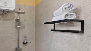 a bathroom with a shower with towels on a wall at Hakika Homes in Olmotoni +40 photos