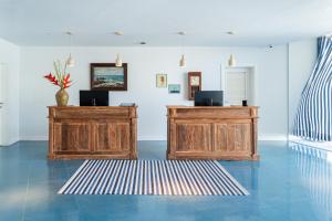a room with two wooden cabinets and a rug at The Salmar - Adults Only in San Miguel de Abona +173 photos