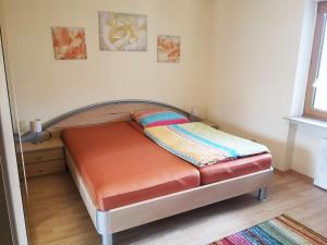 a bed in a room with a bed frame at Ferienwohnung Grosso in Gräfendorf