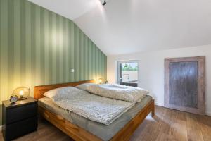 a bedroom with a bed and a green wall at Hof Wuushöh in Stolk