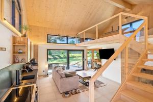 a tiny house with a staircase and a living room at Tiny House in Pischelsdorf am Engelbach