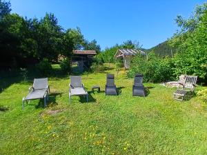 a group of chairs sitting in the grass at Le Rucher de St Pierre in Sainte-Marie-aux-Mines