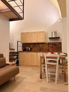a kitchen and dining room with a table and chairs at Stella Apartment in Nardò