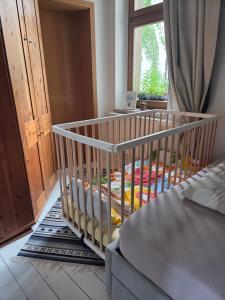 a crib in a bedroom with a window at Apartment 1 im Martinsgarten Angermünde in Angermünde