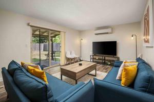 a living room with a blue couch and a tv at Wintergreen Unit 1 in Salem