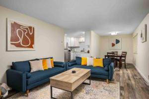 a living room with two blue couches and a table at Wintergreen Unit 1 in Salem