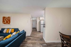 a living room with a blue couch and a kitchen at Wintergreen Unit 1 in Salem +13 photos