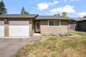 a house with a garage and a fence at Wintergreen Unit 1 in Salem